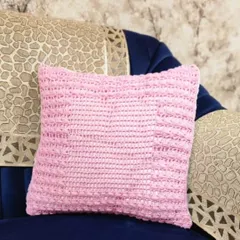 This cushion cover has a simple and elegant textured design. I used a single color of pink cotton yarn to create a lovely pattern that feels as good as it looks.