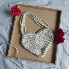 A chic and romantic heart-shaped bag with a pearl strap. This is a perfect accessory for dates or when you want to add a touch of handmade elegance to your outfit. I can make this in other colors too.