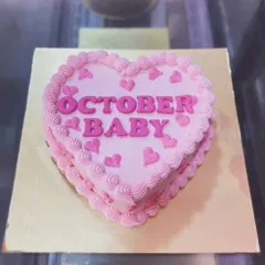 A heart-shaped pink bento cake for an "October Baby."