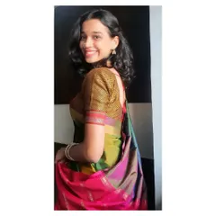 Wearing a traditional multi-colored silk saree for a festive performance. This look is well-suited for cultural events, religious ceremonies, or traditional family functions where a classic aesthetic is desired.