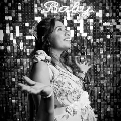 A timeless black and white version of a joyful moment. The mother-to-be's expression of pure happiness is the focus, showing the overwhelming feeling of being celebrated and loved.