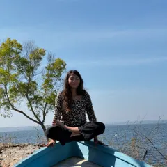 Finding a moment of playful balance on a boat. Yoga doesn't always have to be serious; sometimes it's about exploring your surroundings with curiosity.