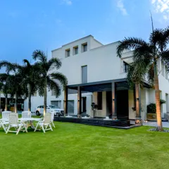 This project showcases how we integrate the home's architecture with the surrounding landscape. The clean lines of the house are softened by the lush lawn and tall palm trees, creating a balanced and sophisticated residential estate.
