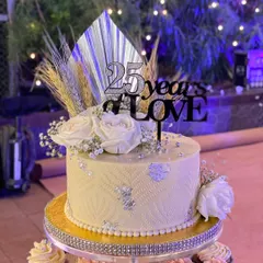 Celebrating 25 years of love with this elegant anniversary cake. I used a delicate stencil pattern, silver leaf, and fresh white roses, with a custom topper to mark the special occasion.
