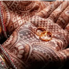 A powerful, symbolic shot of wedding rings resting on a hand with intricate henna. This style of photography tells a story and is highly effective for marketing engagement rings and wedding bands.