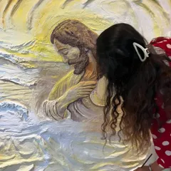 Adding the final touches of color to the textured robes of Jesus. This part of the process requires immense patience, as I build up layers of paint to create realistic shadows and highlights on the sculpted surface.