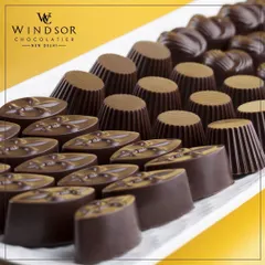 A platter showcasing some of my classic dark chocolate shapes. I create a wide range of molded chocolates that are perfect for filling custom gift boxes or for serving at events.