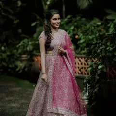 A full-length portrait of the bride-to-be in her stunning pink and silver lehenga, looking radiant and happy.