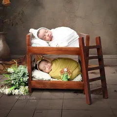 Bunk bed buddies for life. This creative setup features twin newborns sleeping soundly in a miniature bunk bed, a sweet nod to their shared journey ahead.