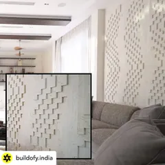 This is a limestone panel in the bar area with a meticulously crafted texture. The geometric, stepped pattern creates a beautiful play of light and shadow, turning a simple wall into a sophisticated architectural feature.