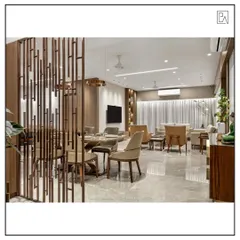 This image showcases an open-plan living and dining area where a decorative metal partition creates a subtle separation without closing off the space. The consistent use of materials and a neutral color palette ensures a harmonious flow throughout.