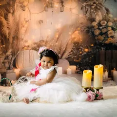 An example of a dreamy and elegant pre-birthday photoshoot. For this session with Sarveksha, we used soft lighting, candles, and a beautiful floral backdrop to create a magical, fairytale atmosphere. I can create any theme you imagine for your child's portraits.