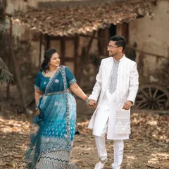 A walk to remember. This beautiful shot from an engagement session captures the couple in stunning traditional attire, sharing a happy moment together.