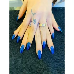 Make a bold statement with this vibrant royal blue. This look features perfectly shaped, long almond nails coated in a high-gloss, solid blue gel polish for a clean, striking, and confident finish.