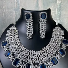 A still photo of the magnificent blue stone and diamond choker. The craftsmanship is clear in this image, showing a high-quality piece available for rent.