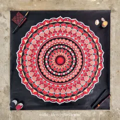 A custom 60x60cm mandala in a powerful red, black, and white color combination. The bold colors and sharp contrasts make for a dramatic and eye-catching piece of wall art.