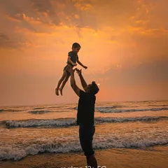 A heartfelt silhouette of a father and child against a golden sunset at the beach. This image is all about emotion and capturing a fleeting, joyful moment.