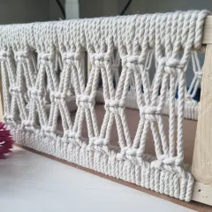 A close-up of the diamond knot pattern on the side of the basket, woven with thick, durable cotton cord.