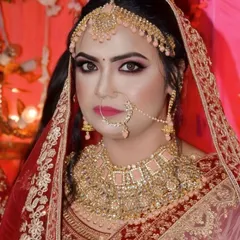 A close up portrait showcasing the balance between bold eyes and a defined lip. The pink toned jewelry is perfectly matched with the makeup, tying the whole look together.