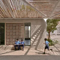 We love the play of light and shadow at the Talaricheruvu Rural School in Andhra Pradesh. The bamboo canopy and perforated jaali walls create a dynamic, comfortable environment for the children, showcasing how thoughtful design can have a profound social impact.