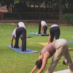 Guiding my students through Parsvottanasana (Pyramid Pose) during an outdoor class. This hamstring stretch is excellent for improving flexibility in the legs and lower back.