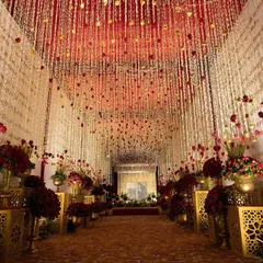 I believe a wedding entrance should be nothing short of breathtaking. For this Sufiyana-themed evening, I designed a grand walkway with thousands of suspended floral strings and traditional brass urns, creating a path that felt both royal and divine. This is how I set the stage for an unforgettable celebration.