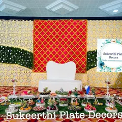 An elegant engagement plate display at Annur. The symmetry of the arrangement and the rich colours of the stage create a regal look.