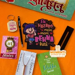Here is a complete Rakshabandhan gift combo for a sister. It includes a 'Ek Hazaro Mein Meri Behna Hai' tabletop, a bar pendant, a pen, a keychain, and other lovely items.