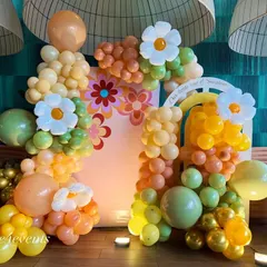 For a fun and groovy celebration, we designed this retro-inspired balloon backdrop. The arrangement features a unique color palette of orange, yellow, and green, with cheerful daisy accents for a bright and happy vibe.