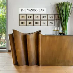 The Tango Bar is one of my most iconic pieces, inspired by the fluid movement of paper waves. Crafted from antique brass, its sculptural form is designed to be the protagonist in any room. It’s a functional bar that doubles as a piece of art, perfect for servicing a lounge, living room, or even an outdoor space.