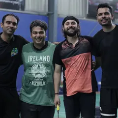 A team of four takes a break between matches. The smiles and easy camaraderie are exactly what we aim to foster. This is team building in its most natural and effective form.