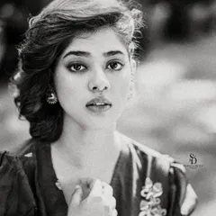 A grainy, film-like black and white portrait. This editing style adds a layer of texture and nostalgia, giving the image a timeless, artistic quality.