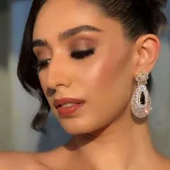 A detailed close-up of the sunset glam look. You can see the seamless blend of the brown smokey eyeshadow, the sharp winged liner, and the glossy nude lip that completes this polished look.