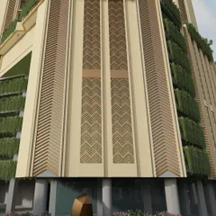 This detailed shot of the Mulund project facade showcases the integration of vertical gardens. The greenery contrasts with the geometric patterns and textures of the building materials, bringing a natural element to the urban structure.