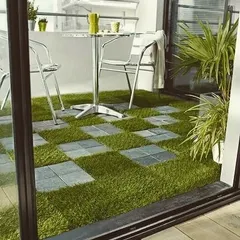 A checkerboard pattern of artificial grass and stone tiles gives this balcony a unique, graphic look. It's a fun and modern flooring solution that is both practical and visually interesting.