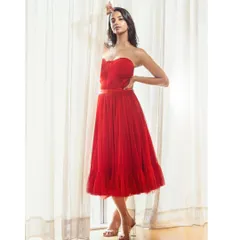 A duplicate of image 16, this image showcases a dramatic red gown styled for a high-fashion editorial, emphasizing silhouette and color.