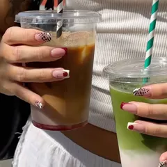 Coffee date with a friend. We both have our fresh, custom nail sets.