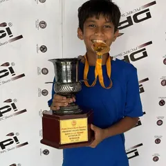 Khush Modi proudly holding his championship trophy and medal, a result of his dedication.