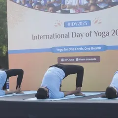 Demonstrating flexibility and strength with a synchronized bridge pose variation on stage.