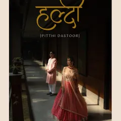 A beautiful poster-style image for the Haldi ceremony, also known as the Pithi Dastoor. The couple stands in a sunlit corridor, creating a dramatic and artistic pre-wedding portrait.
