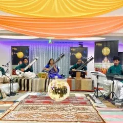 A performance with my fantastic fellow musicians. We are seated on stage, playing a blend of traditional and modern instruments to create our signature symphonic sound.