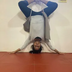 Using props like wall ropes is a key part of my teaching method for advanced poses. Here you can see my students in an inverted Baddha Konasana (Bound Angle Pose), using the ropes to decompress the spine and open the hips safely.