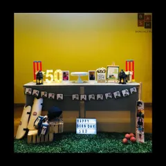 We hit it for a six with this custom cricket theme for a state cricketer's 50th birthday. The decor features a personalized 'Happy Born Day' lightbox, marquee numbers, and authentic cricket gear like pads, a helmet, and a custom photo bat to celebrate his passion.