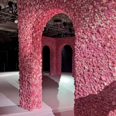A view through the floral arches I designed for the Dolly J show. The goal was to create depth and perspective, making the runway feel like a journey through a surreal, flower-laden palace.