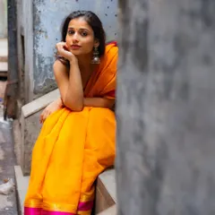 Finding a perfect little nook to sit and pose. The textures of the old wall and steps add so much character to this street portrait.