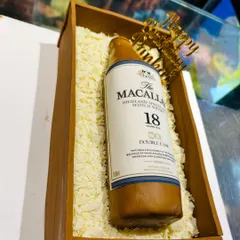 Another angle of the incredibly detailed Macallan whisky bottle cake, a perfect surprise for a connoisseur.