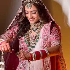 A candid moment showing the bride's happiness. The soft glam makeup ensures she looks radiant and natural throughout her wedding day.
