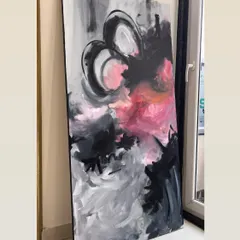 A large abstract canvas with expressive strokes of black, grey, and vibrant pink. This style is perfect for making a bold, modern statement in a living room or creative office space.