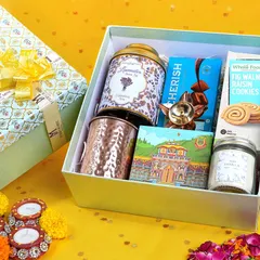 An open gift box showcasing a variety of products like cookies, tea, and a mug. We style and shoot hampers to highlight the value and appeal of the items inside.