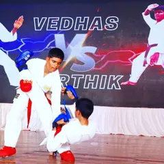 Two of our male students engaged in a sparring match. This image captures the intensity and focus needed to anticipate an opponent's move and execute a counter-technique.